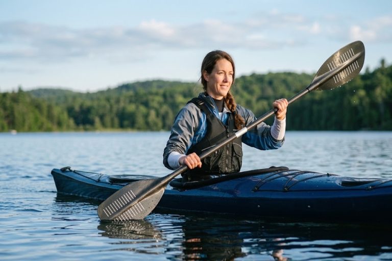 Kayaker paddling on a calm lake
