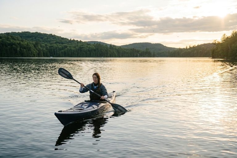 Kayaker paddling at sunset